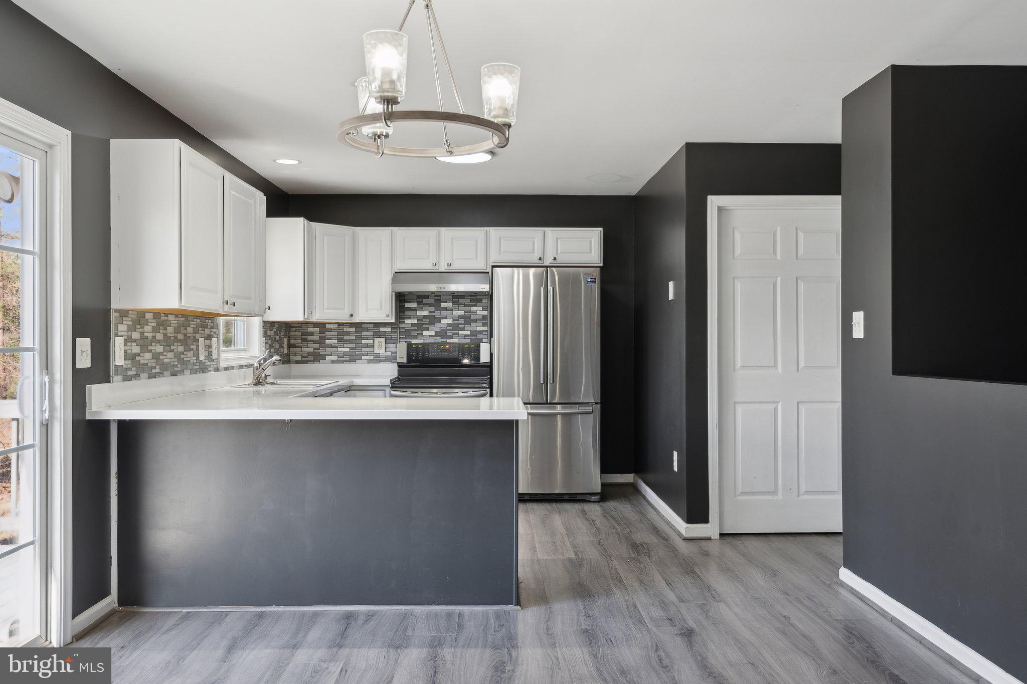 6169 Vance Lane Culpeper, VA 22701 - Photo 6 of 44 a kitchen with stainless steel appliances granite countertop a refrigerator a sink and a stove