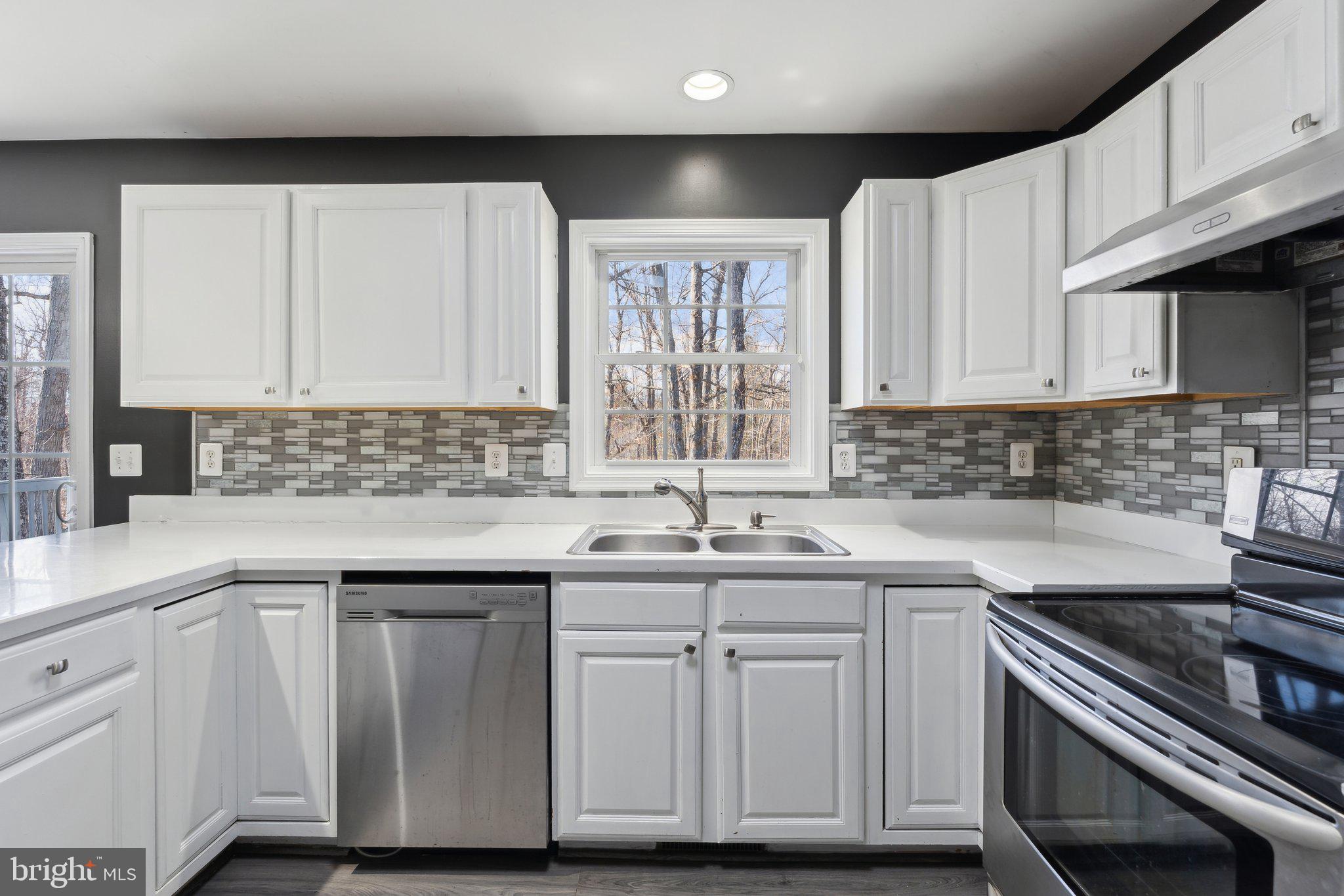 6169 Vance Lane Culpeper, VA 22701 - Photo 10 of 44 a kitchen with cabinets appliances a sink and a window