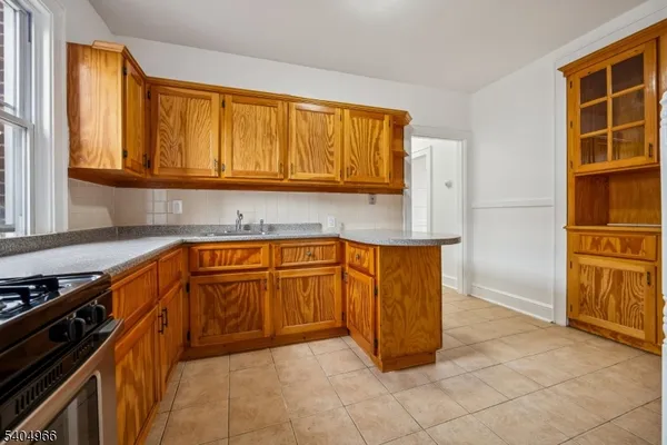 a kitchen with granite countertop a sink and a stove
