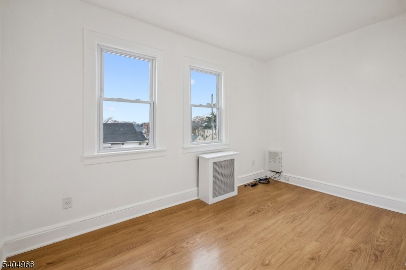 167 Silver Avenue, Unit 2 Hillside, NJ 07205 - Photo 4 of 12 a view of empty room with wooden floor and fan