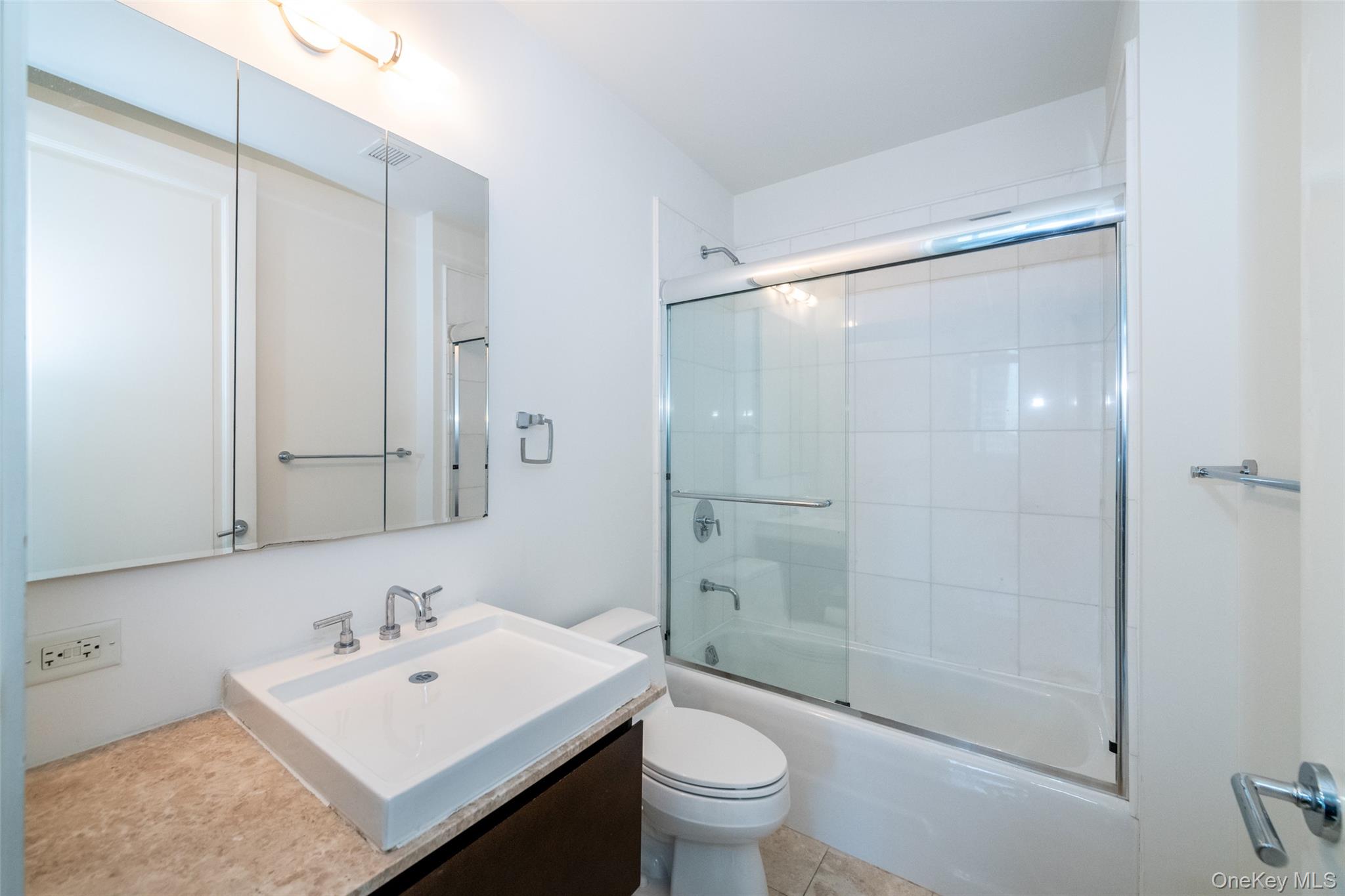 175 Huguenot Street, Unit 1401 New Rochelle, NY 10801 - Photo 11 of 29 a bathroom with a sink toilet and shower
