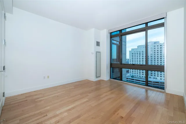 a view of a room with wooden floor and a window