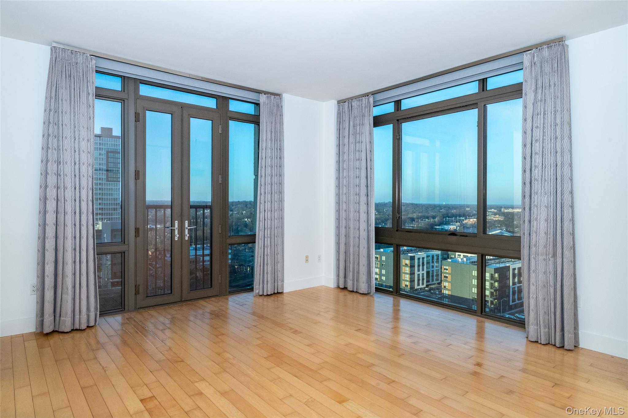 175 Huguenot Street, Unit 1401 New Rochelle, NY 10801 - Photo 3 of 29 a view of an empty room with glass door and balcony