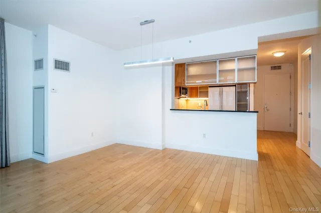a view of a room with wooden floor and a window
