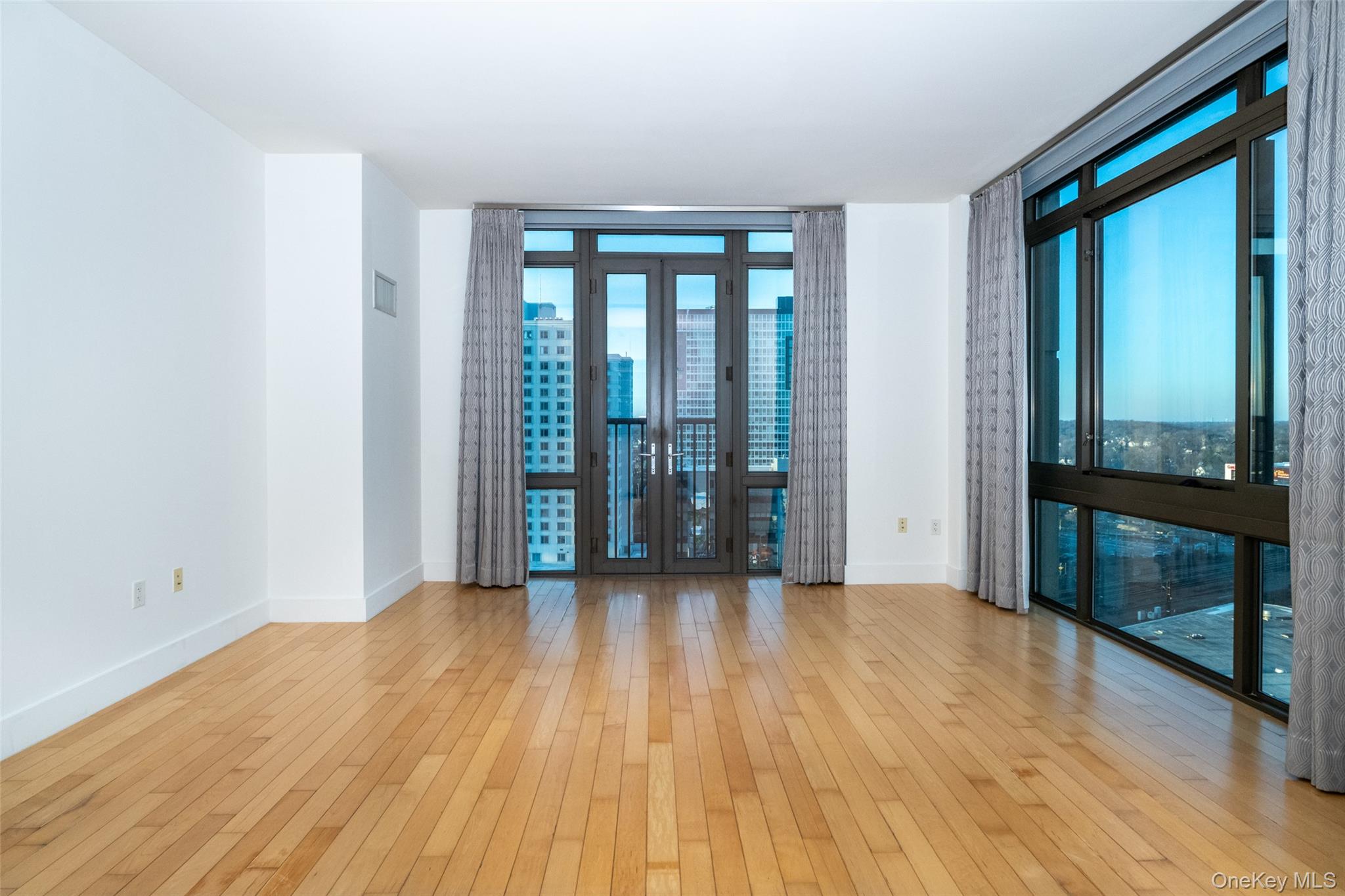 175 Huguenot Street, Unit 1401 New Rochelle, NY 10801 - Photo 9 of 29 a view of an empty room with glass door
