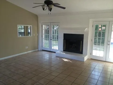a view of a livingroom with a fireplace and window