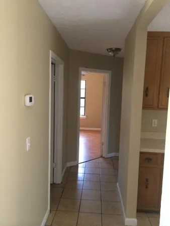 a view of a hallway with wooden shelves
