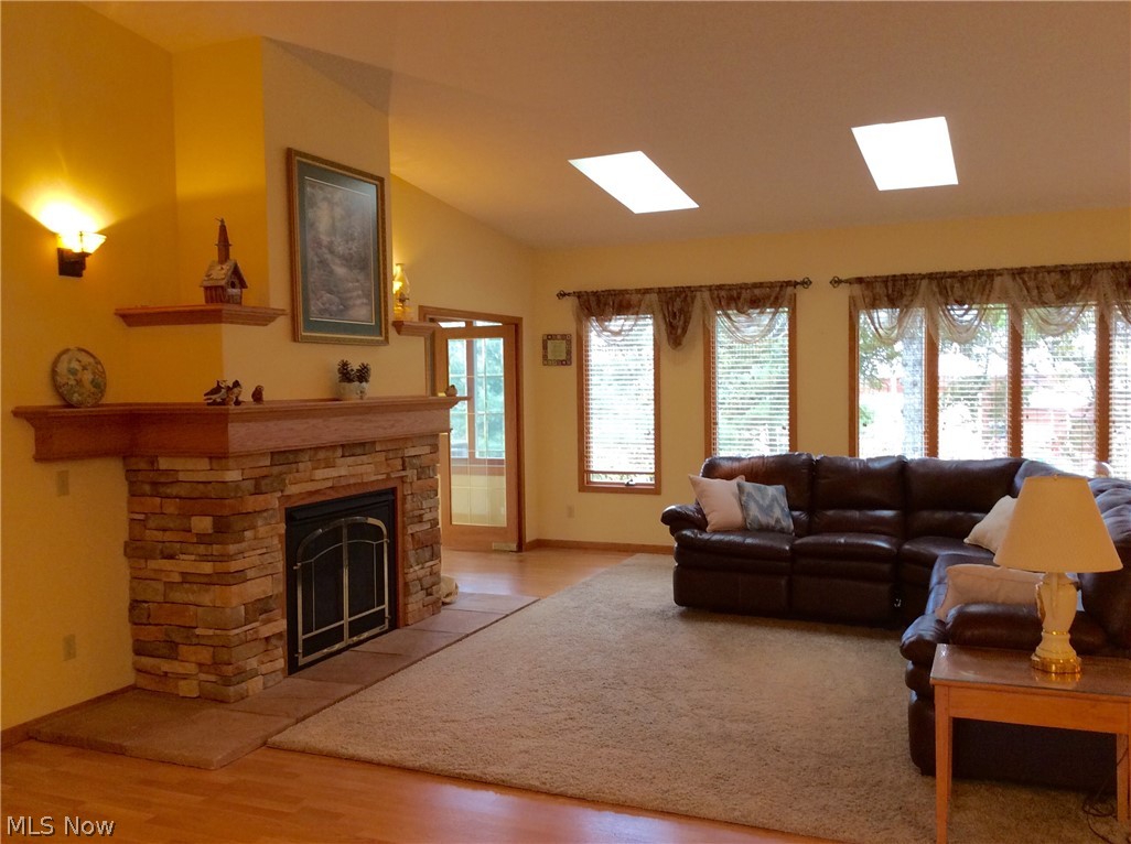 3400 Church Road Medina, OH 44256 - Photo 3 of 24 FANTASTIC VAULTED GREAT ROOM W/WALL OF WINDOWS, SKYLIGHTS, GAS FIREPLACE, WALL SCONCES & LAMINATE FLOORING.