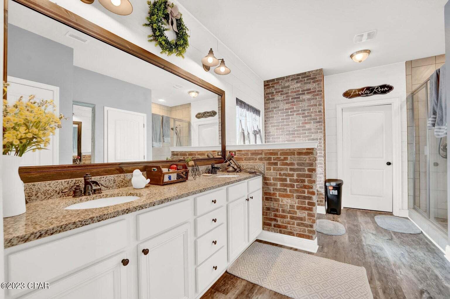 622 Cornelia Street Freeport, FL 32439 - Photo 15 of 43 a bathroom with a granite countertop double vanity sink and mirror