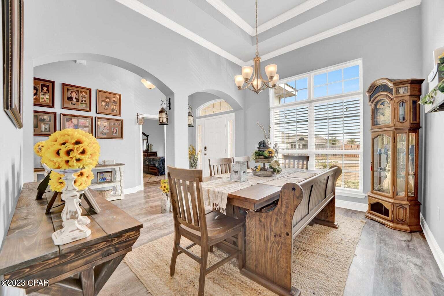 622 Cornelia Street Freeport, FL 32439 - Photo 16 of 43 a view of a dining room with furniture a chandelier and wooden floor