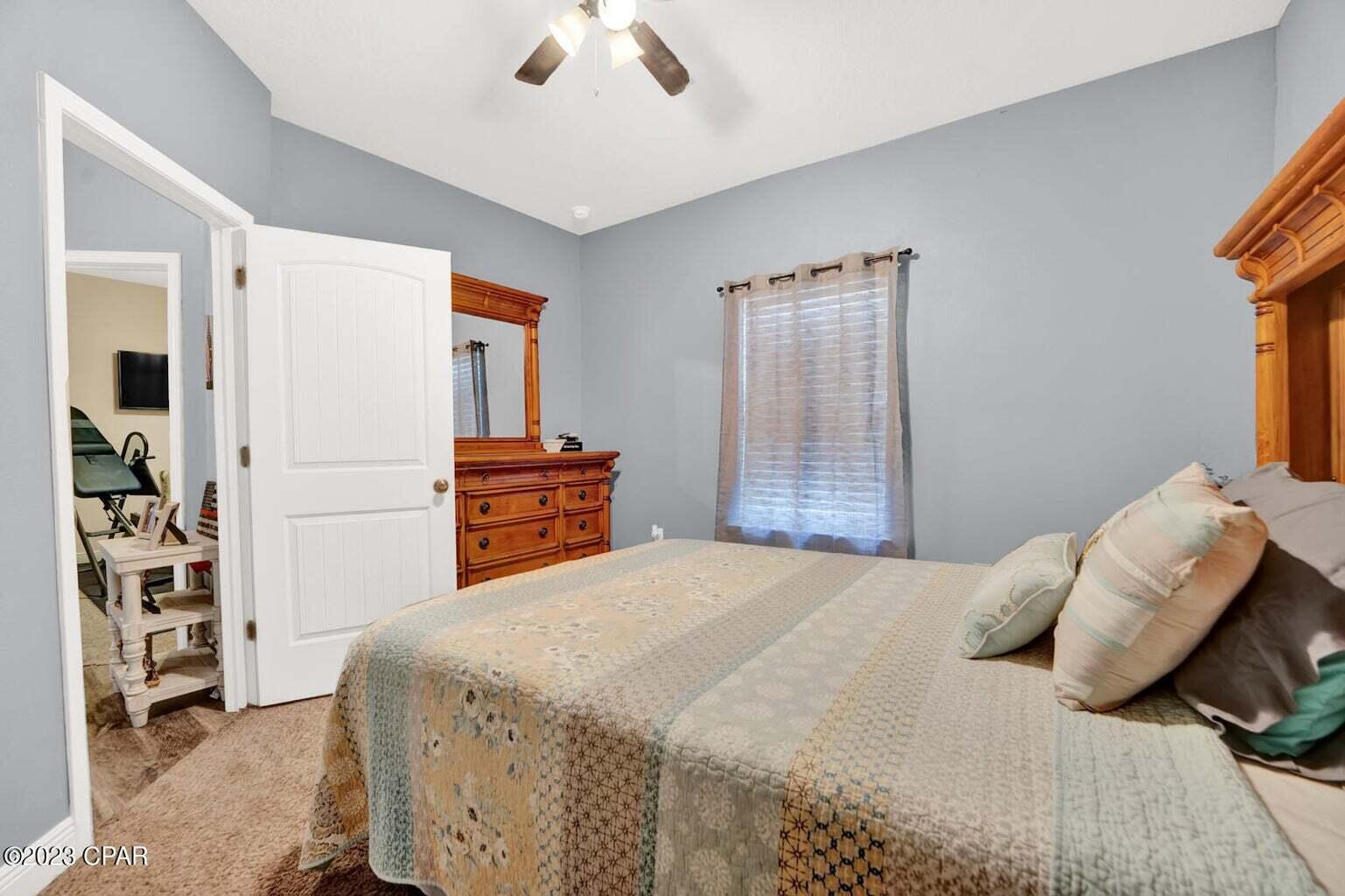 622 Cornelia Street Freeport, FL 32439 - Photo 20 of 43 a bedroom with a large bed and a window