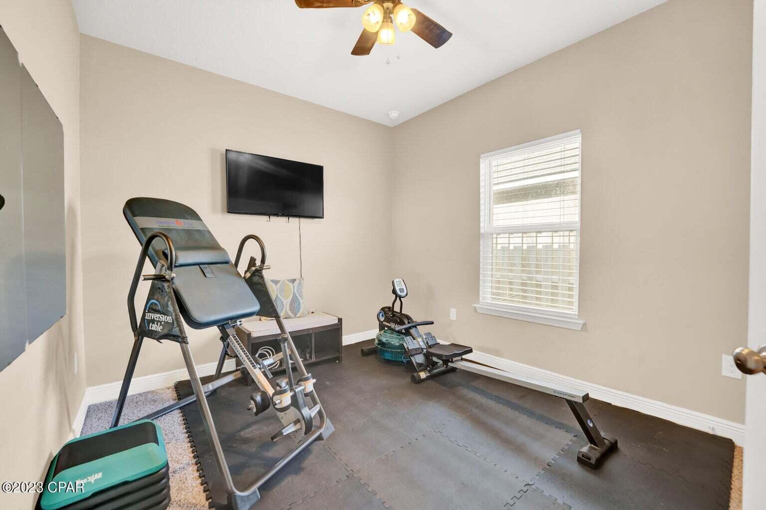 622 Cornelia Street Freeport, FL 32439 - Photo 21 of 43 a room with gym equipment and windows