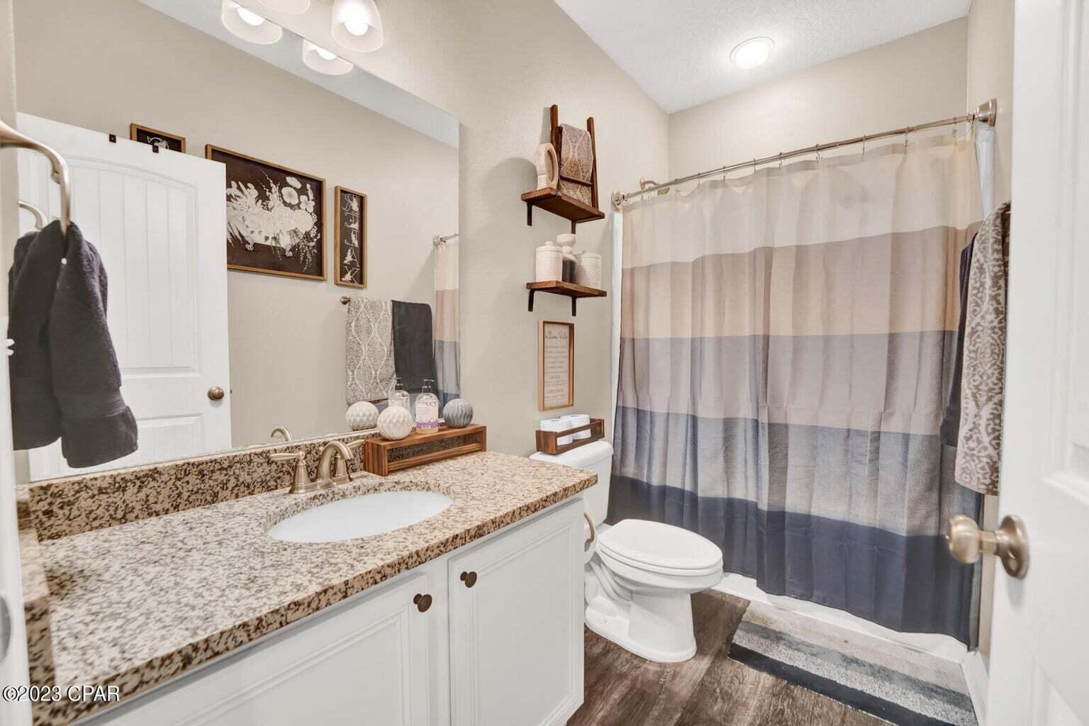 622 Cornelia Street Freeport, FL 32439 - Photo 22 of 43 a bathroom with a granite countertop sink toilet and shower
