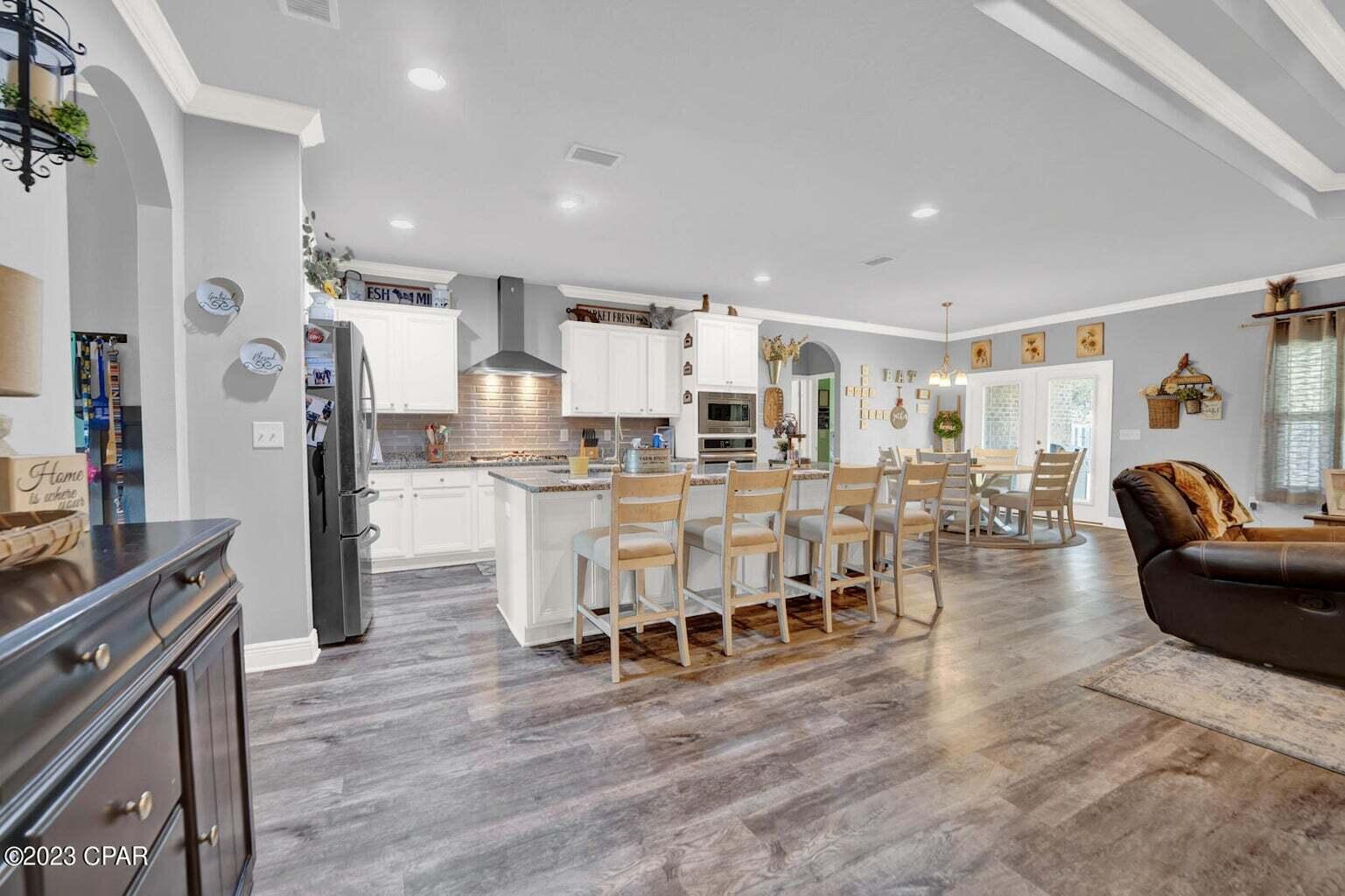 622 Cornelia Street Freeport, FL 32439 - Photo 23 of 43 a living room with lots of furniture and kitchen view