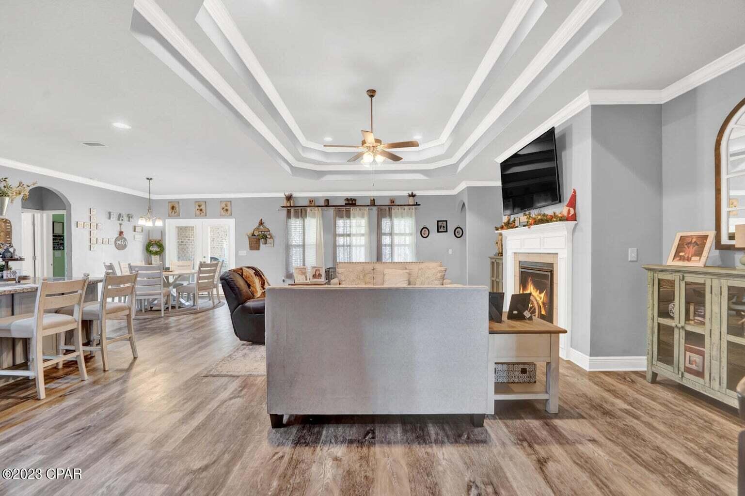 622 Cornelia Street Freeport, FL 32439 - Photo 24 of 43 a living room with kitchen island furniture and a flat screen tv