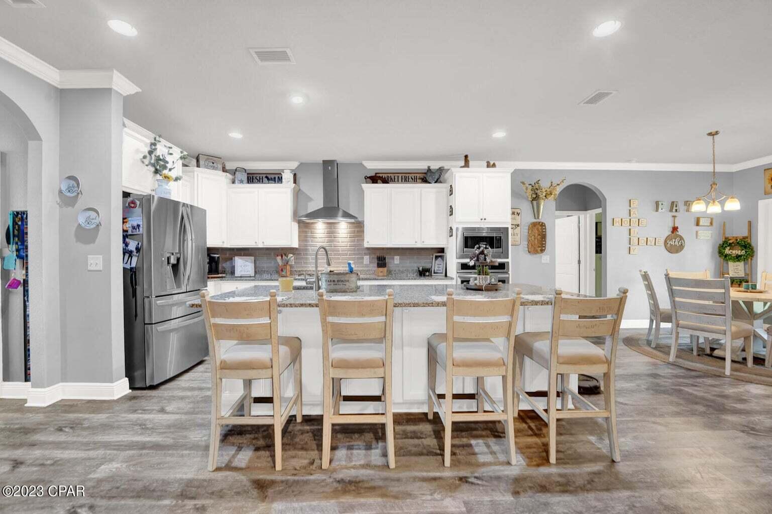 622 Cornelia Street Freeport, FL 32439 - Photo 25 of 43 a kitchen with stainless steel appliances kitchen island granite countertop a refrigerator and cabinets