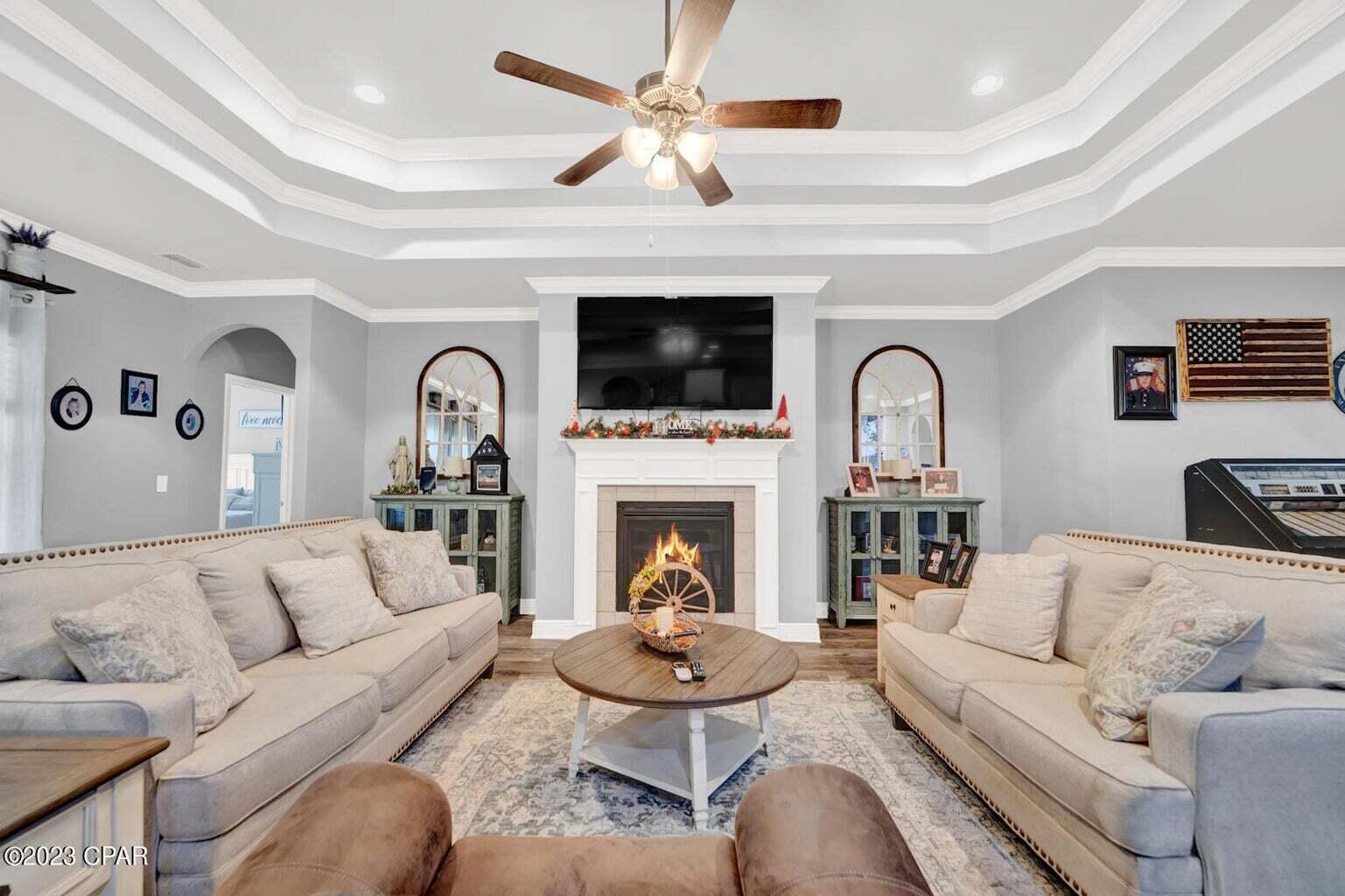 622 Cornelia Street Freeport, FL 32439 - Photo 27 of 43 a living room with furniture a fireplace and a flat screen tv