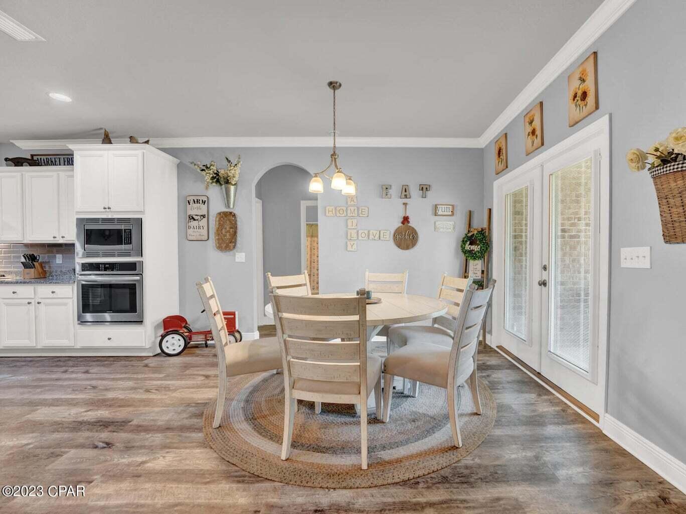 622 Cornelia Street Freeport, FL 32439 - Photo 28 of 43 a dining room filled with furniture and wooden floor