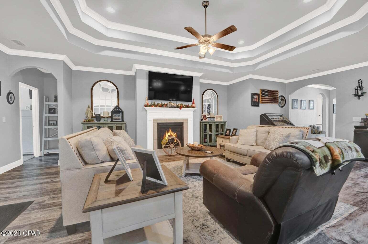 622 Cornelia Street Freeport, FL 32439 - Photo 3 of 43 a living room with furniture a fireplace and a flat screen tv