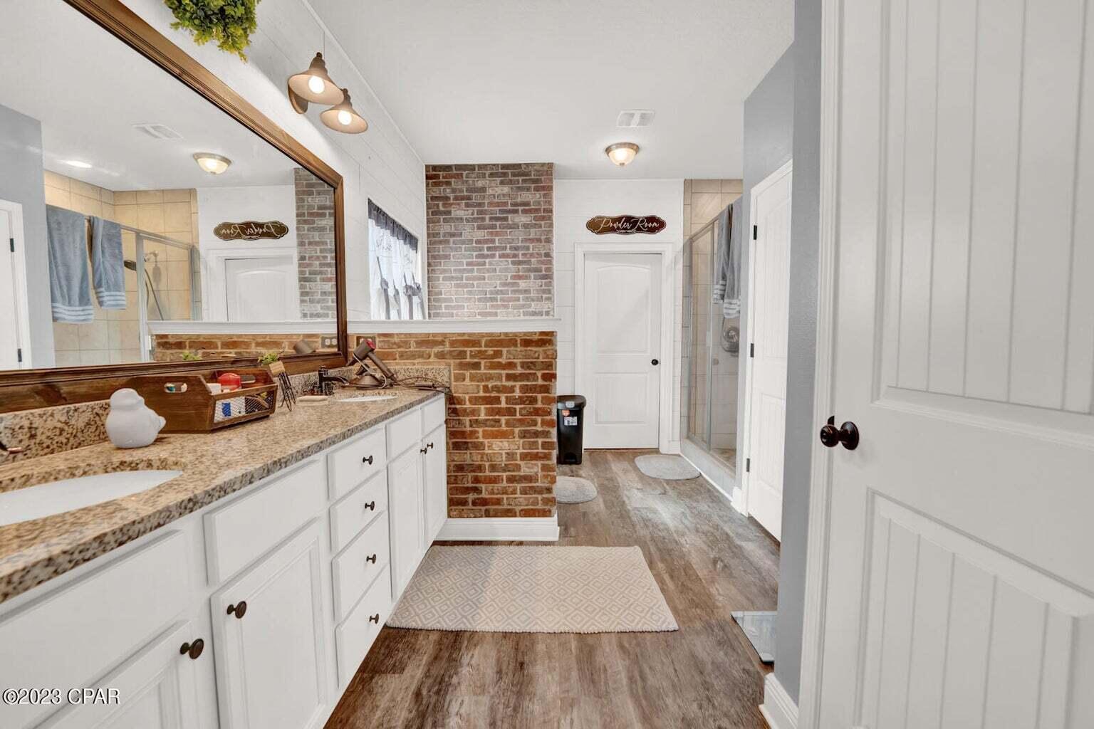 622 Cornelia Street Freeport, FL 32439 - Photo 31 of 43 a spacious bathroom with double vanity and mirrors