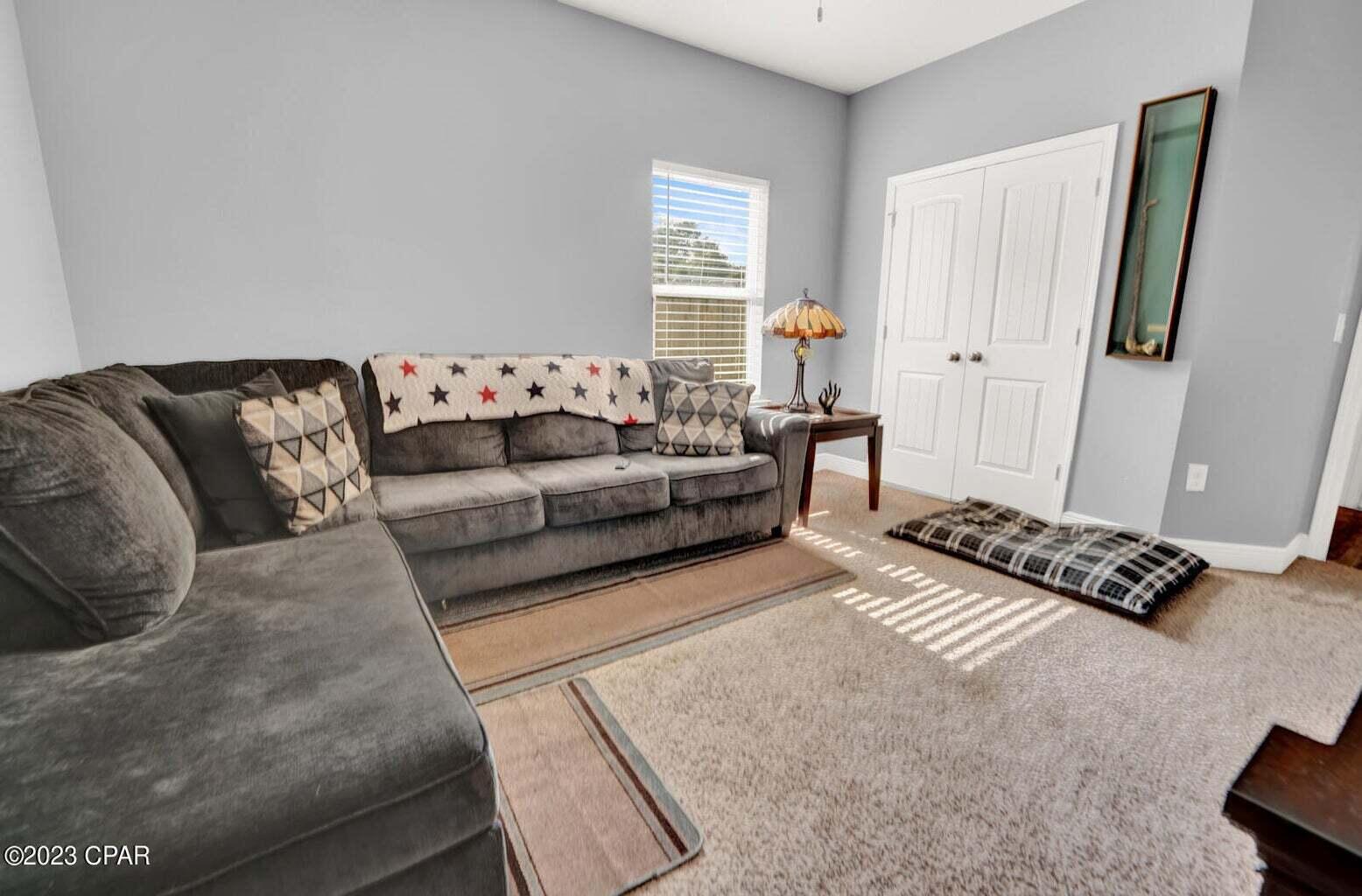 622 Cornelia Street Freeport, FL 32439 - Photo 33 of 43 a living room with furniture rug and a window