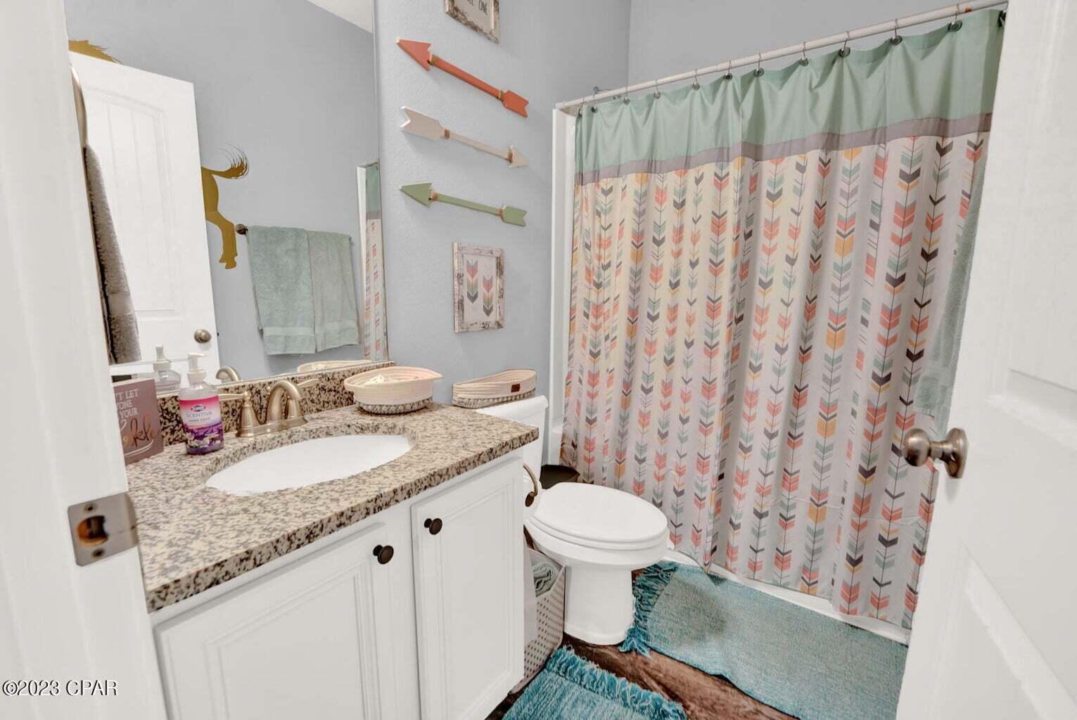 622 Cornelia Street Freeport, FL 32439 - Photo 35 of 43 a bathroom with a granite countertop sink toilet and shower
