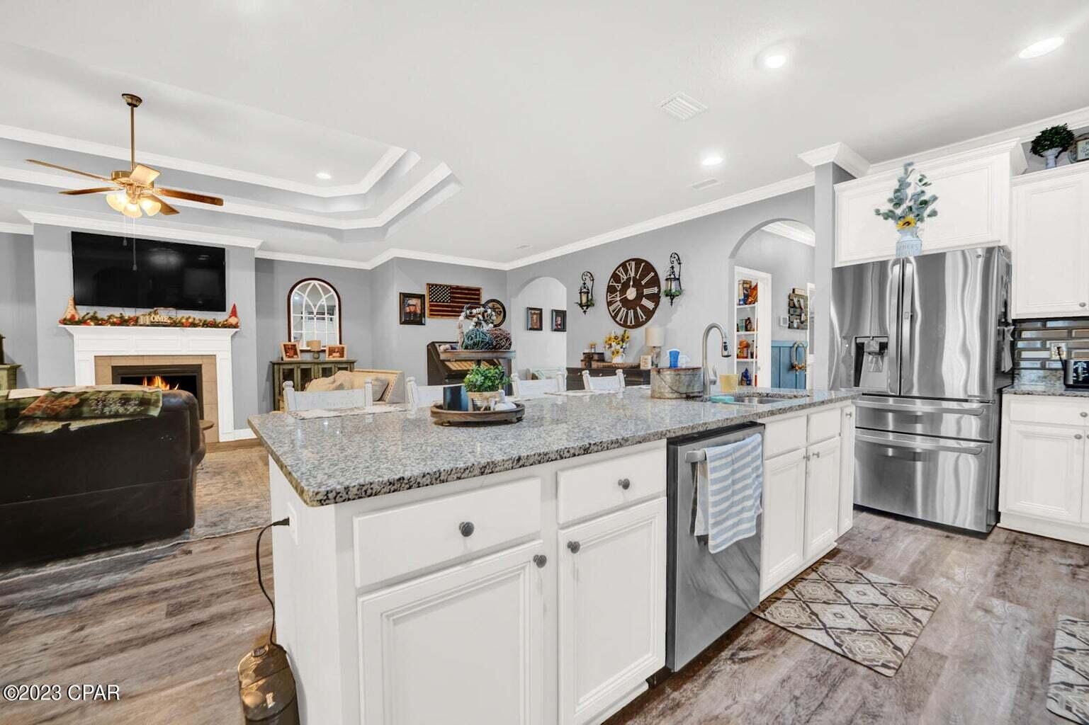 622 Cornelia Street Freeport, FL 32439 - Photo 4 of 43 a kitchen with stainless steel appliances granite countertop a refrigerator and a stove top oven