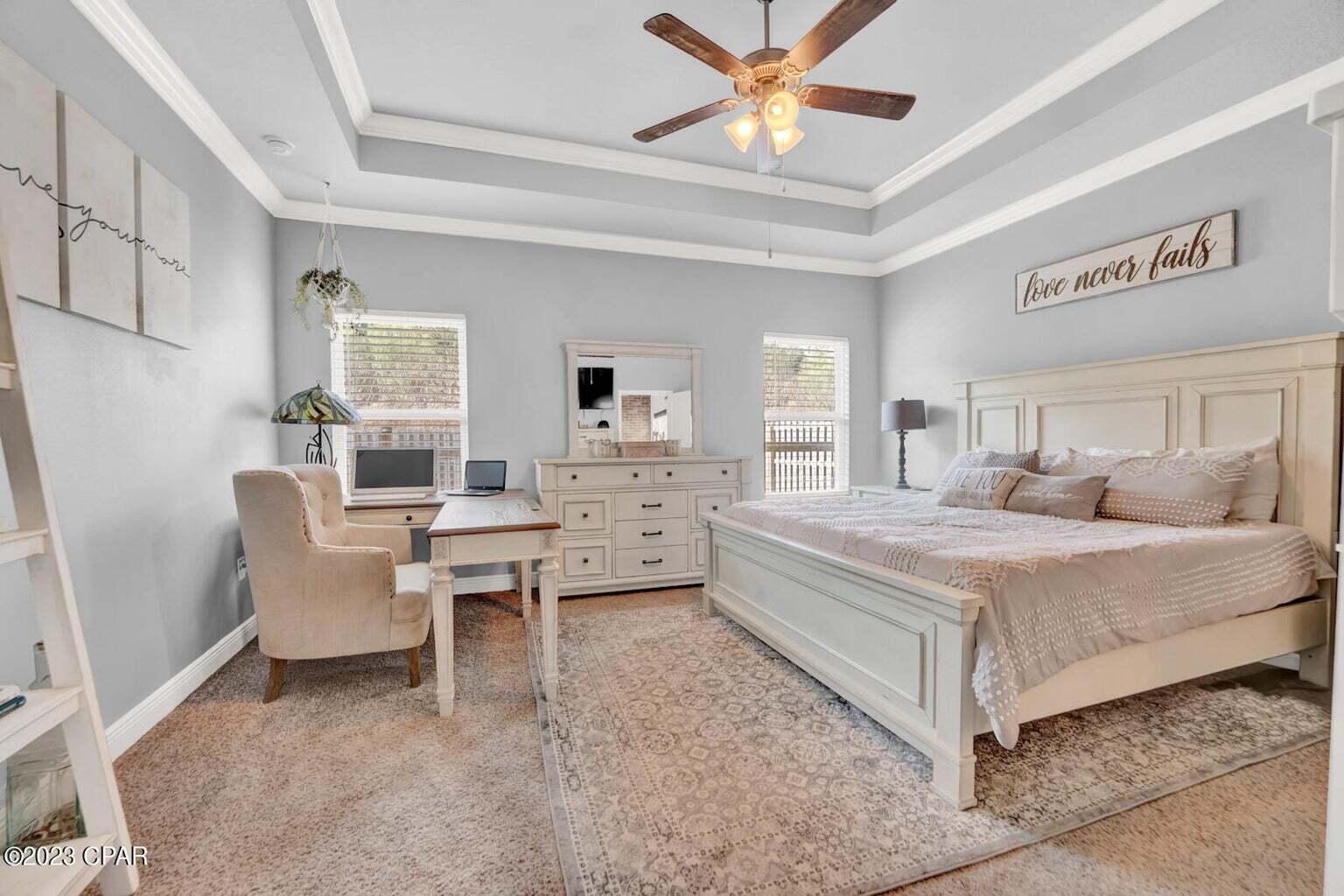 622 Cornelia Street Freeport, FL 32439 - Photo 10 of 43 a bedroom with a bed and a chandelier