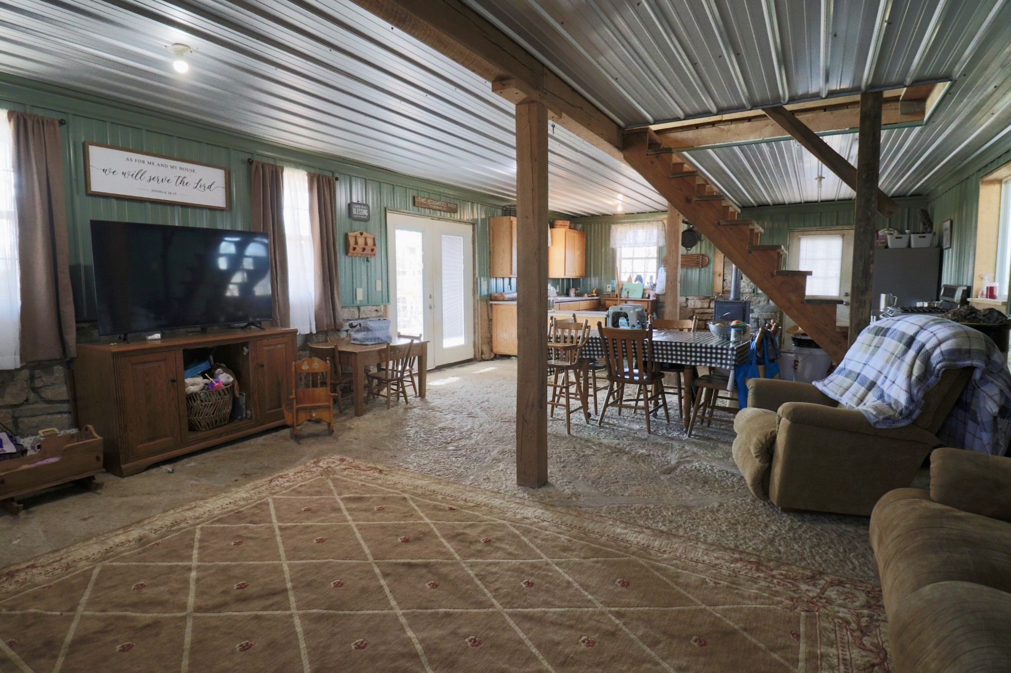 4561 Mayberry Prong Road Linden, TN 37096 - Photo 16 of 27 a living room with furniture a flat screen tv and kitchen view