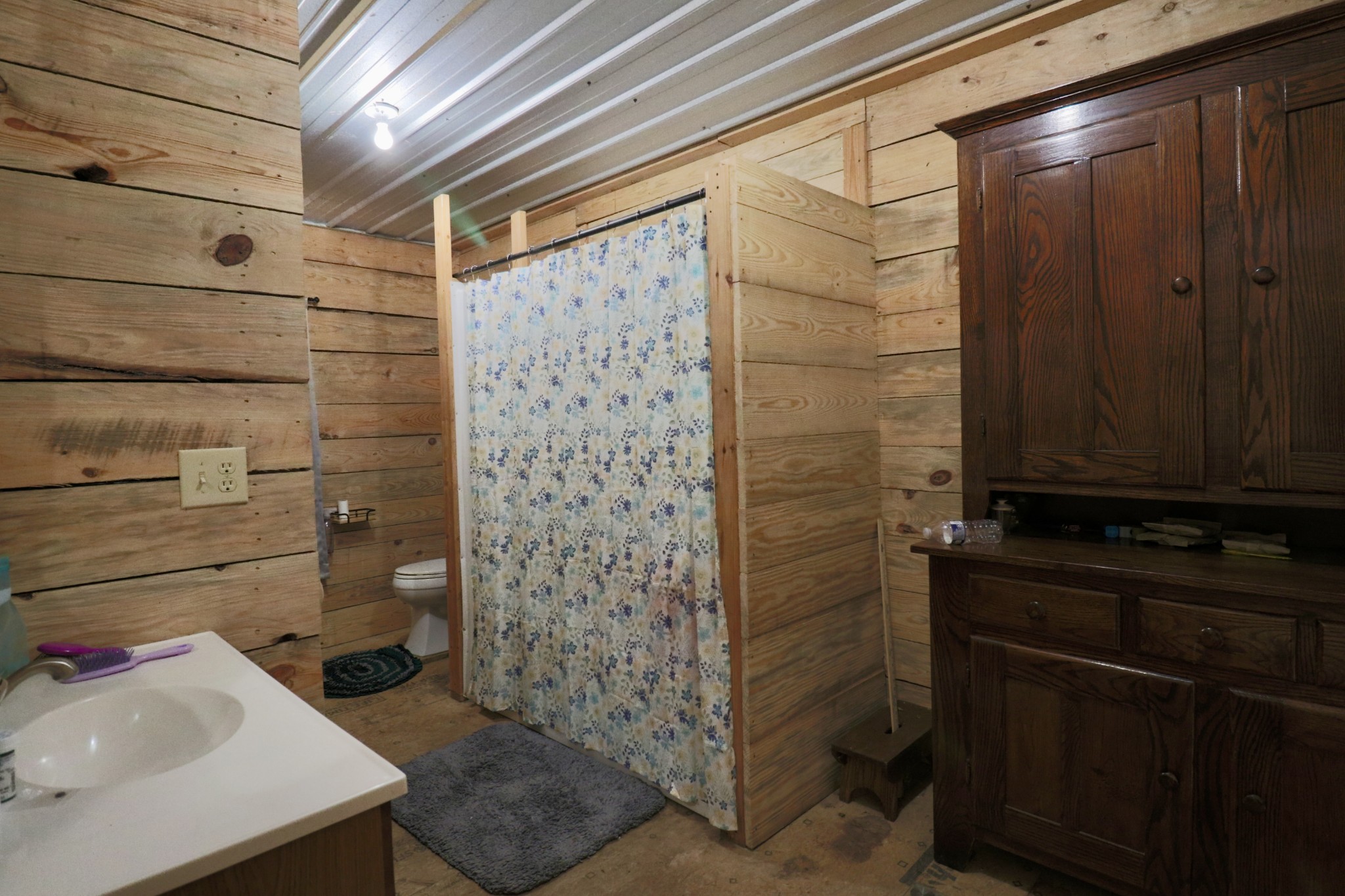 4561 Mayberry Prong Road Linden, TN 37096 - Photo 21 of 27 a bathroom with a sink a toilet and shower