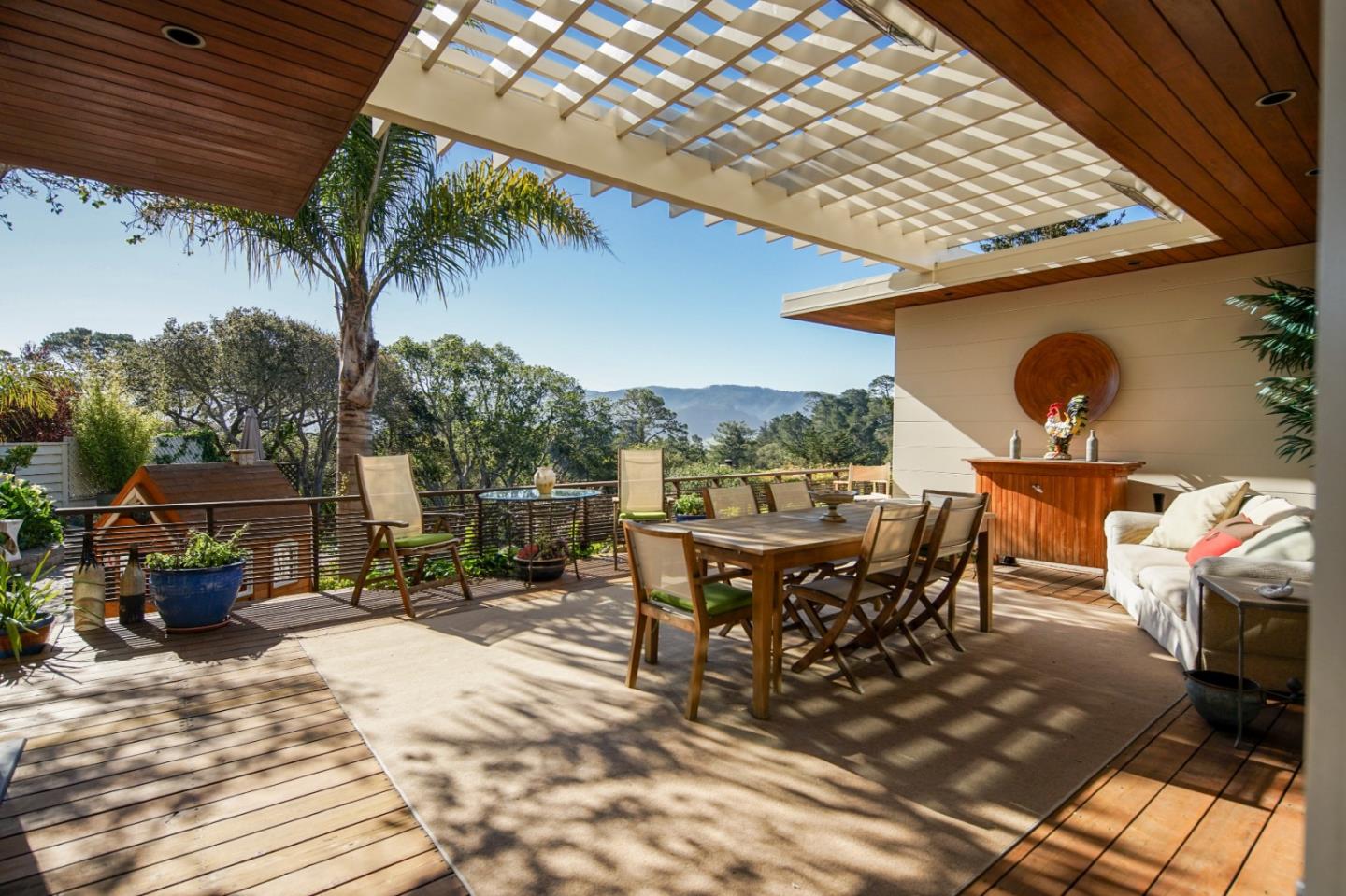 25233 Ward Place Carmel, CA 93923 - Photo 1 of 1 a view of a patio with table and chairs with wooden floor and fence
