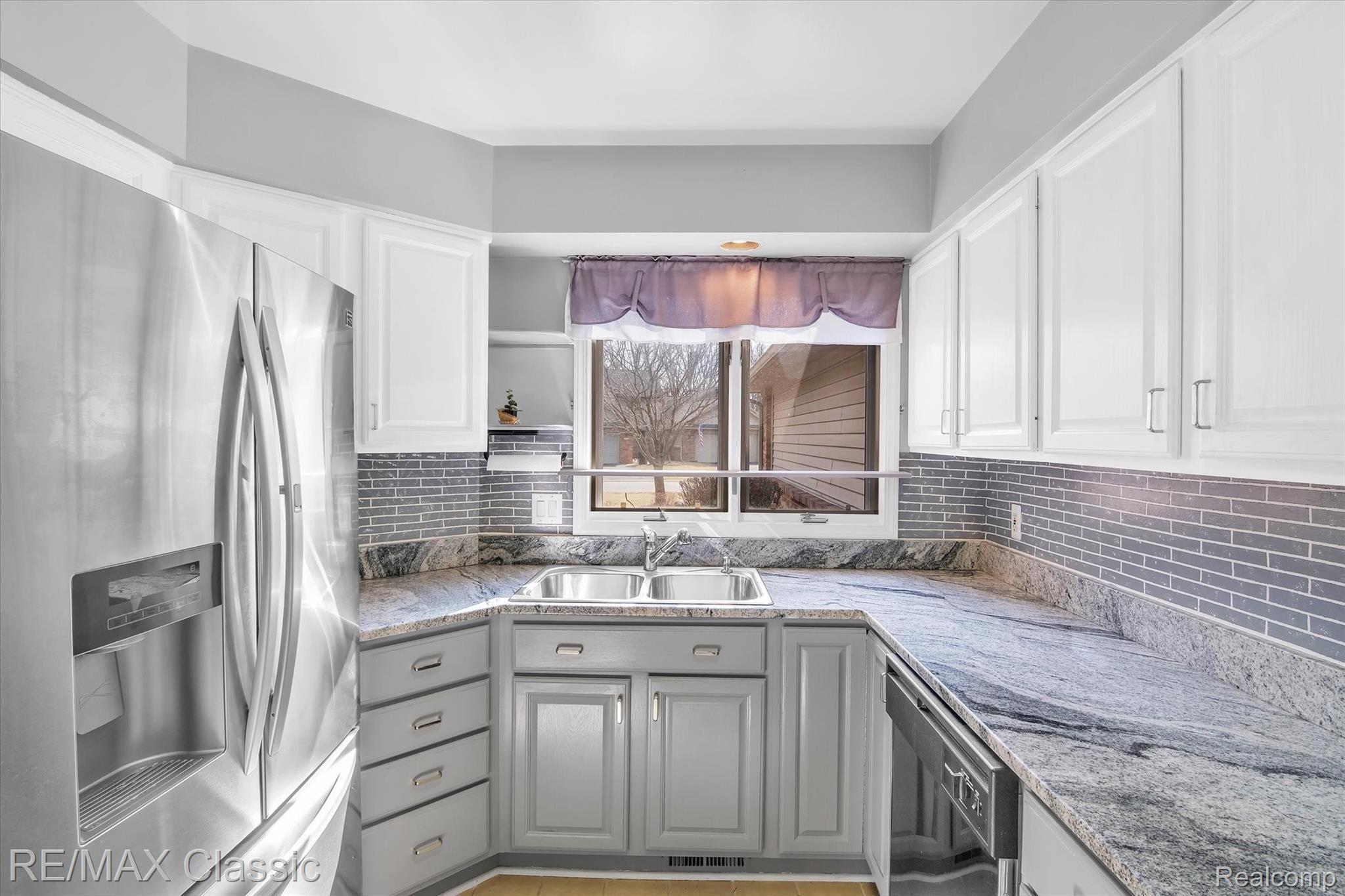 3036 Rivers Edge Drive Wayne, MI 48184 - Photo 13 of 33 Updated Kitchen with stone counters stainless appliances , ceramic tiled floor.