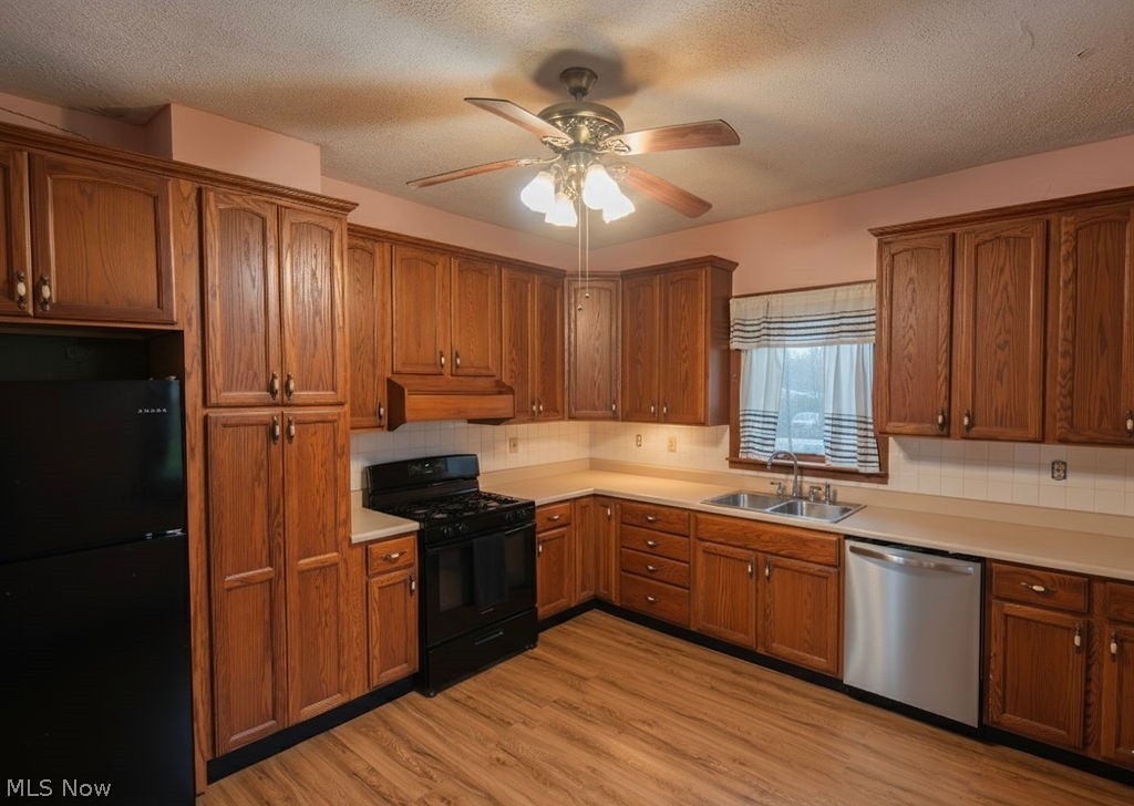 1195 South Johnson Road Sebring, OH 44672 - Photo 4 of 34 Kitchen featuring black appliances, light countertops, wood finish cabinetry, ceiling fan, and light wood-style flooring