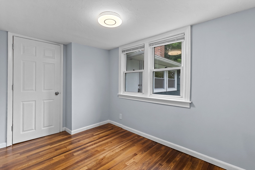 5 Phoenix Street Worcester, MA 01604 - Photo 24 of 32 a view of empty room with window and wooden floor