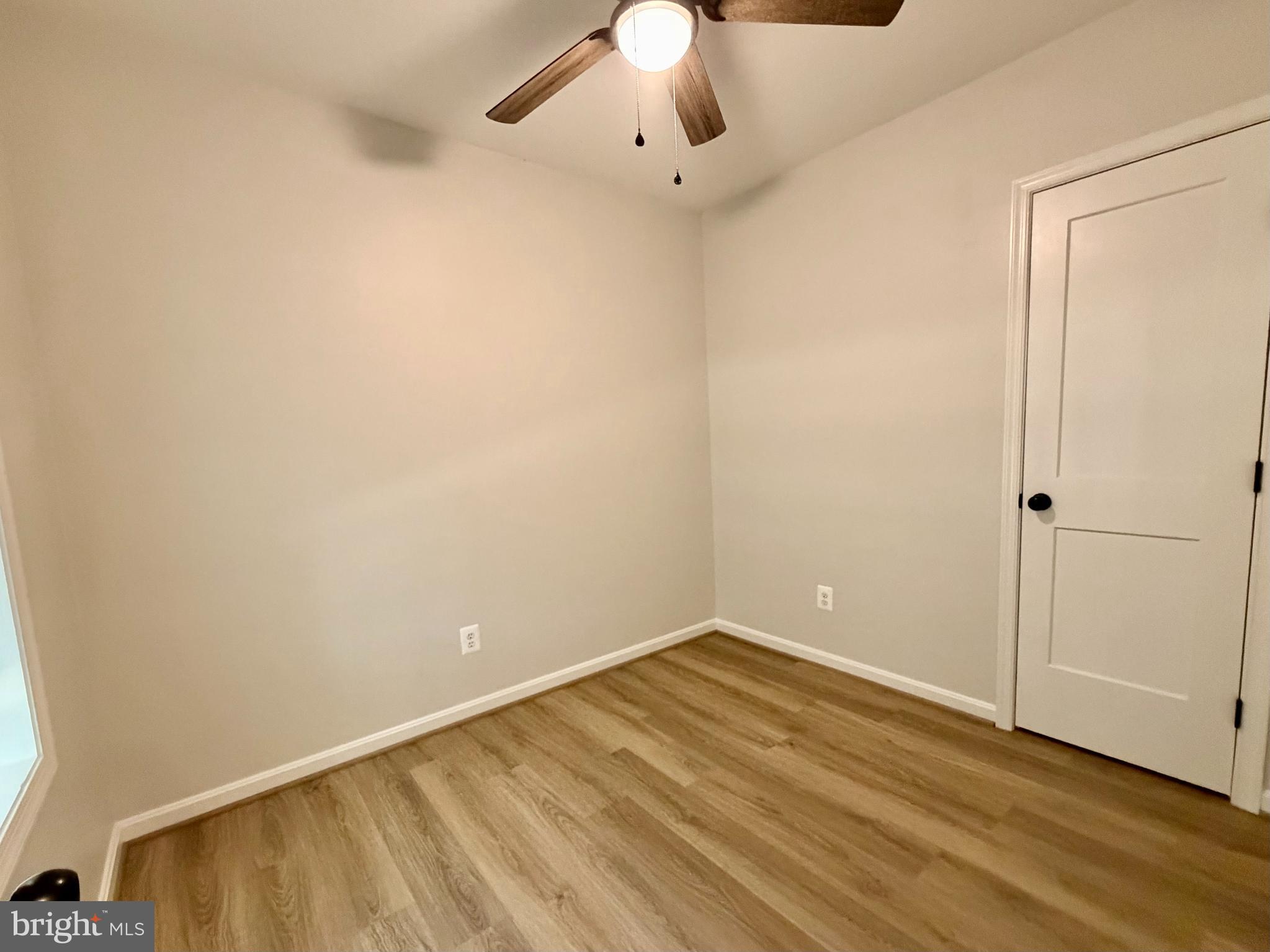 17476 Piney Point Road, Unit 12 Piney Point, MD 20690 - Photo 4 of 10 a view of an empty room with wooden floor