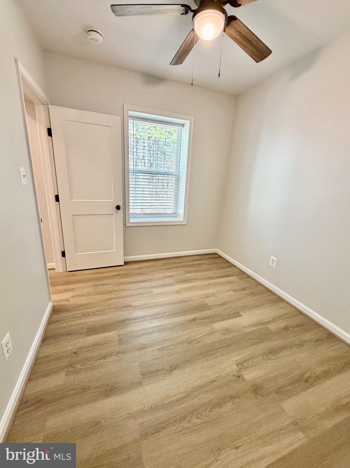 17476 Piney Point Road, Unit 12 Piney Point, MD 20690 - Photo 5 of 10 an empty room with wooden floor and chandelier fan