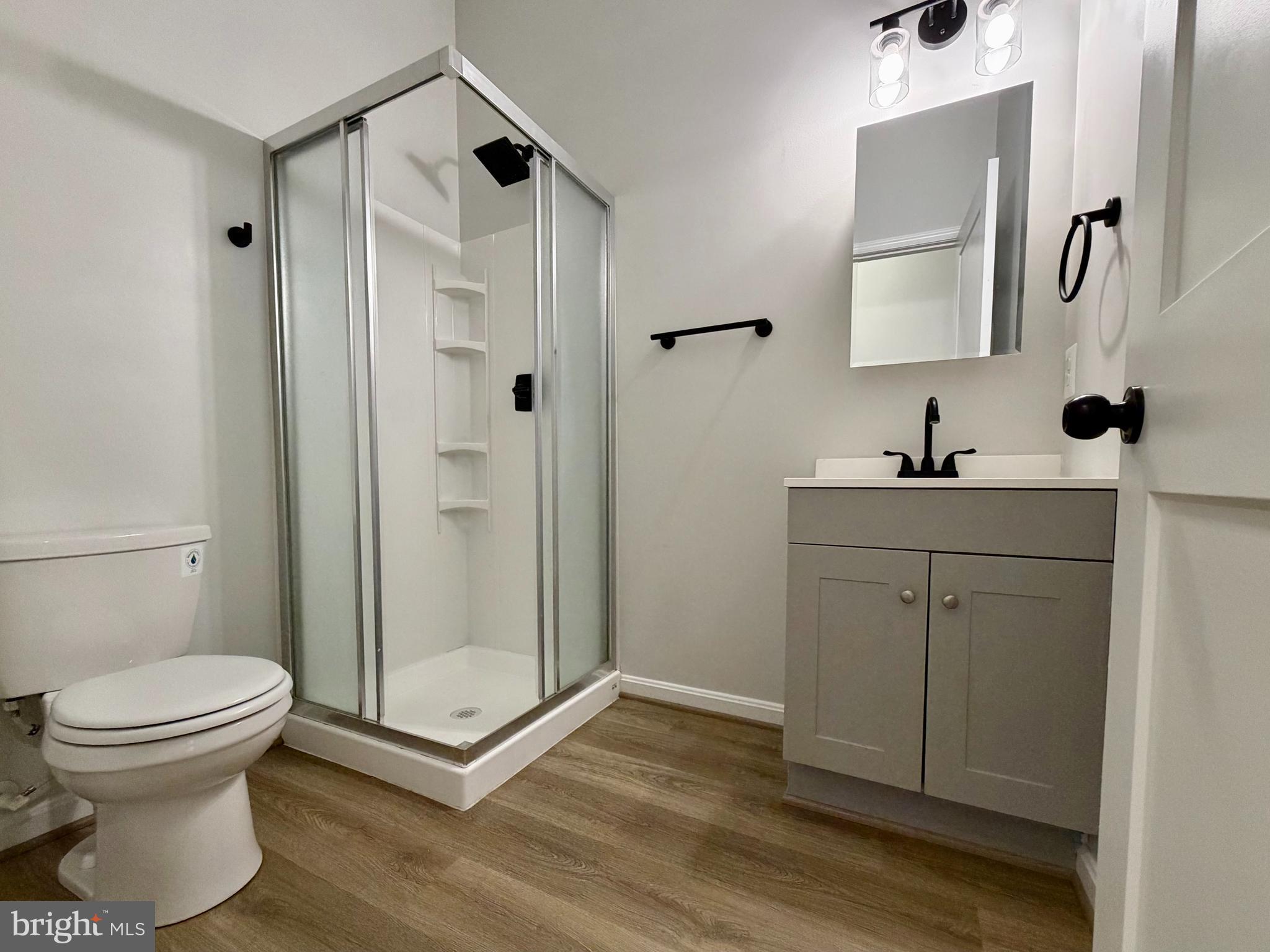 17476 Piney Point Road, Unit 12 Piney Point, MD 20690 - Photo 6 of 10 a bathroom with a toilet sink and a mirror