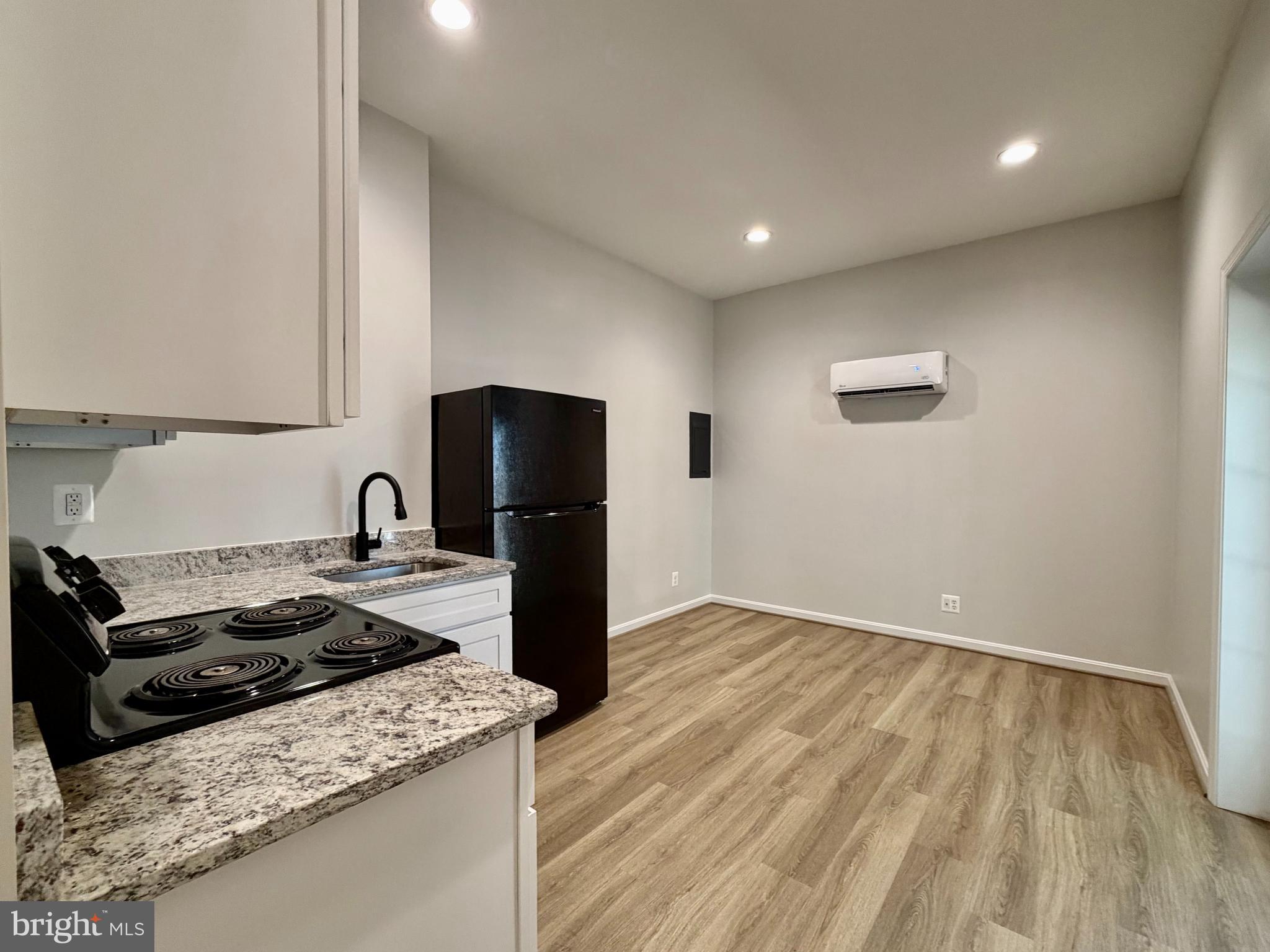 17476 Piney Point Road, Unit 12 Piney Point, MD 20690 - Photo 7 of 10 a kitchen that has a sink and a stove in it
