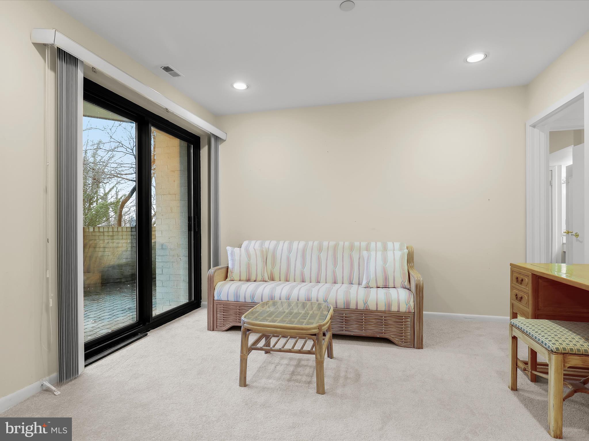 4001 Old Court Road, Unit 115 Baltimore, MD 21208 - Photo 20 of 31 a living room with furniture and a floor to ceiling window