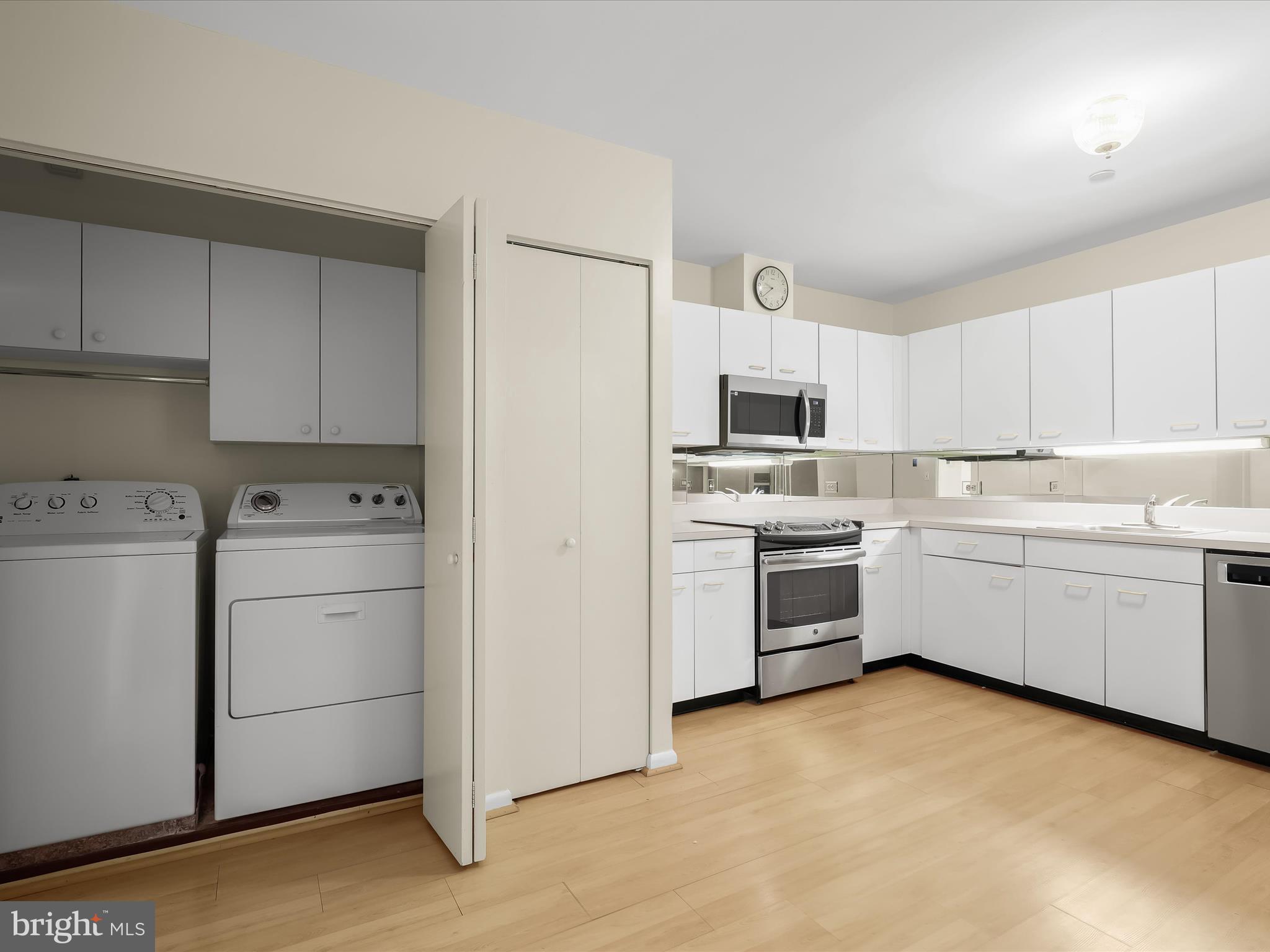 4001 Old Court Road, Unit 115 Baltimore, MD 21208 - Photo 9 of 31 a kitchen with white cabinets and white appliances