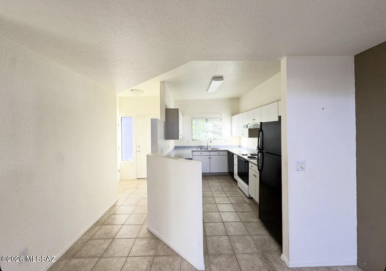 4998 North Valle Road Tucson, AZ 85750 - Photo 2 of 11 a kitchen with a refrigerator and a sink