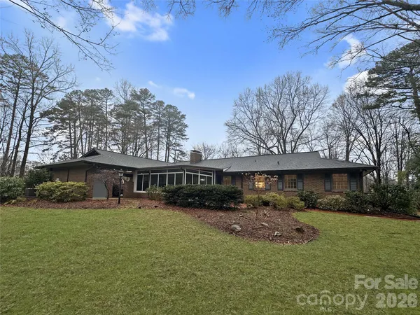 a view of a house with backyard and sitting area