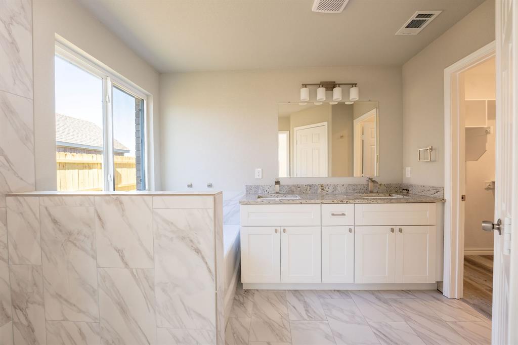 1032 Springview Lane Mabank, TX 75147 - Photo 9 of 15 Full bathroom with double vanity and light marble finish floors