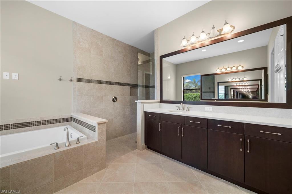 4365 Caldera Circle Naples, FL 34119 - Photo 8 of 23 Bathroom featuring vanity, shower with separate bathtub, and tile patterned flooring
