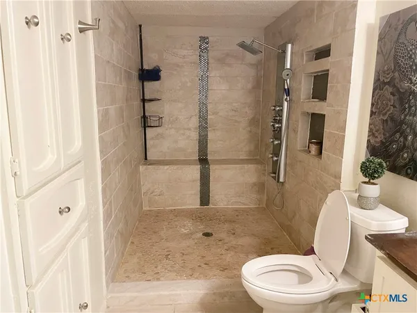 a white toilet sitting next to a bathroom sink