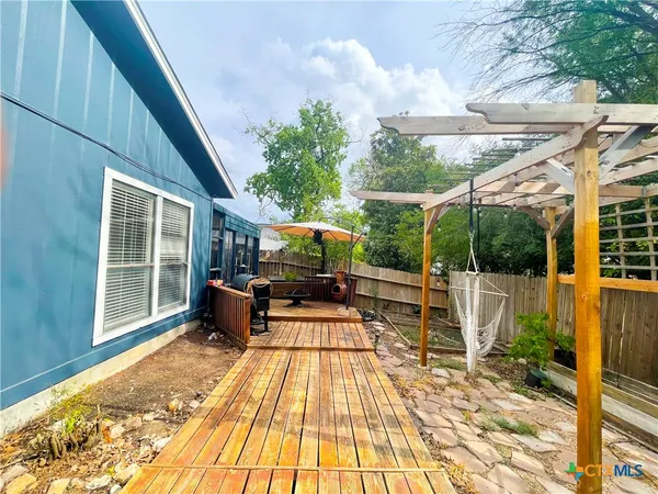 a view of a house with backyard porch and sitting area
