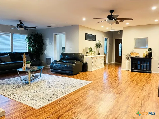 a living room with furniture and wooden floor
