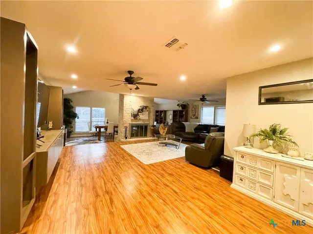 a large kitchen with stainless steel appliances kitchen island a large counter space a sink and a stove