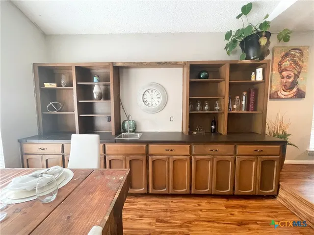 a living room with wooden floor and furniture