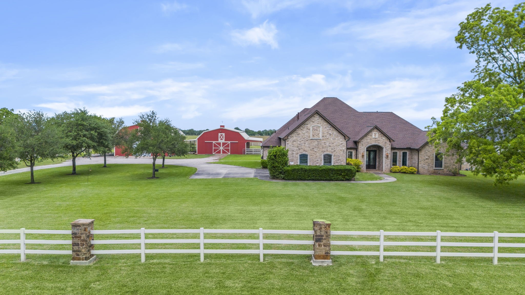 a front view of a house with a yard and trees